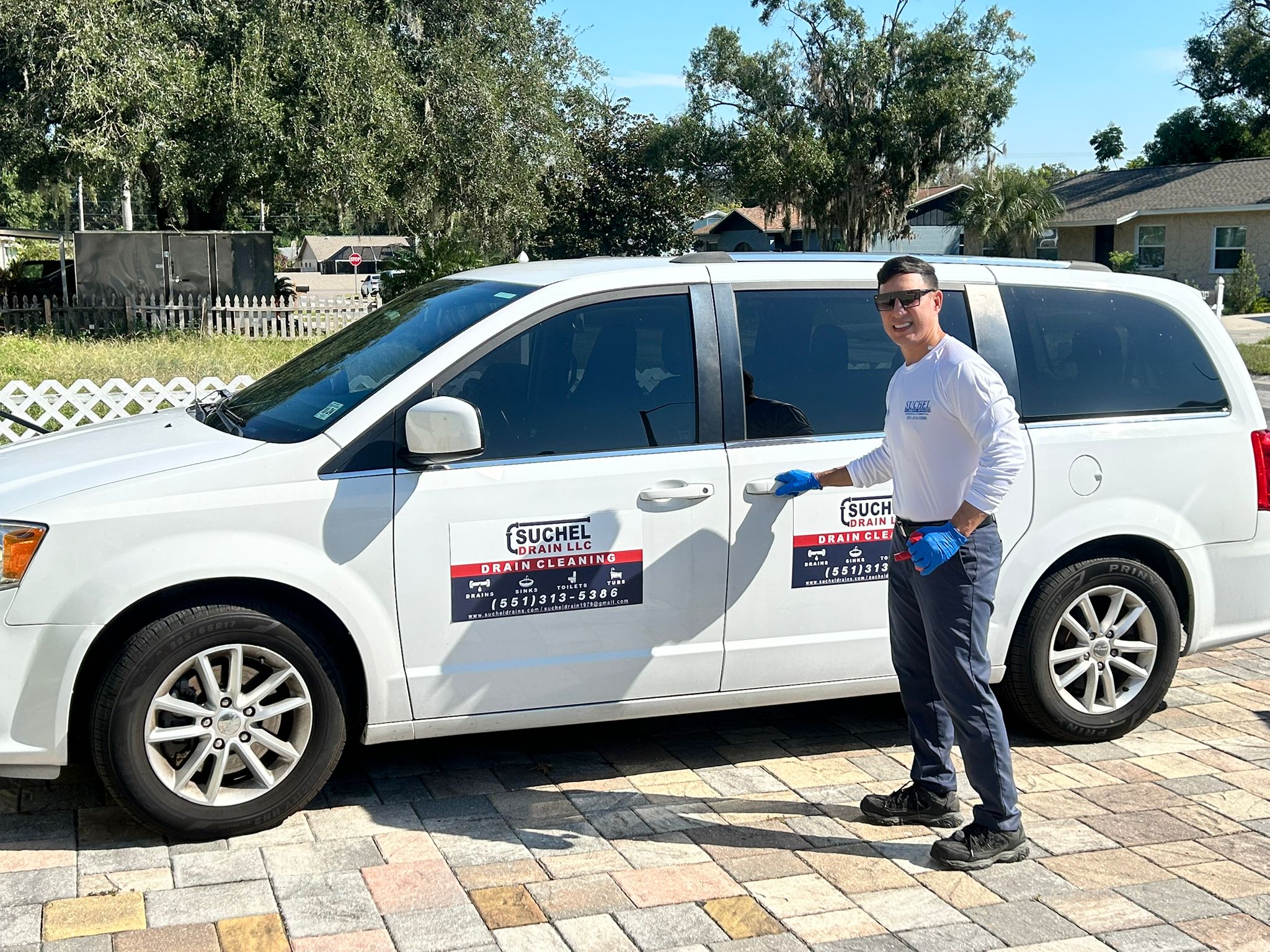 Henry Pacheco, owner of Suchel Drain LLC, beside a Suchel Drain service van